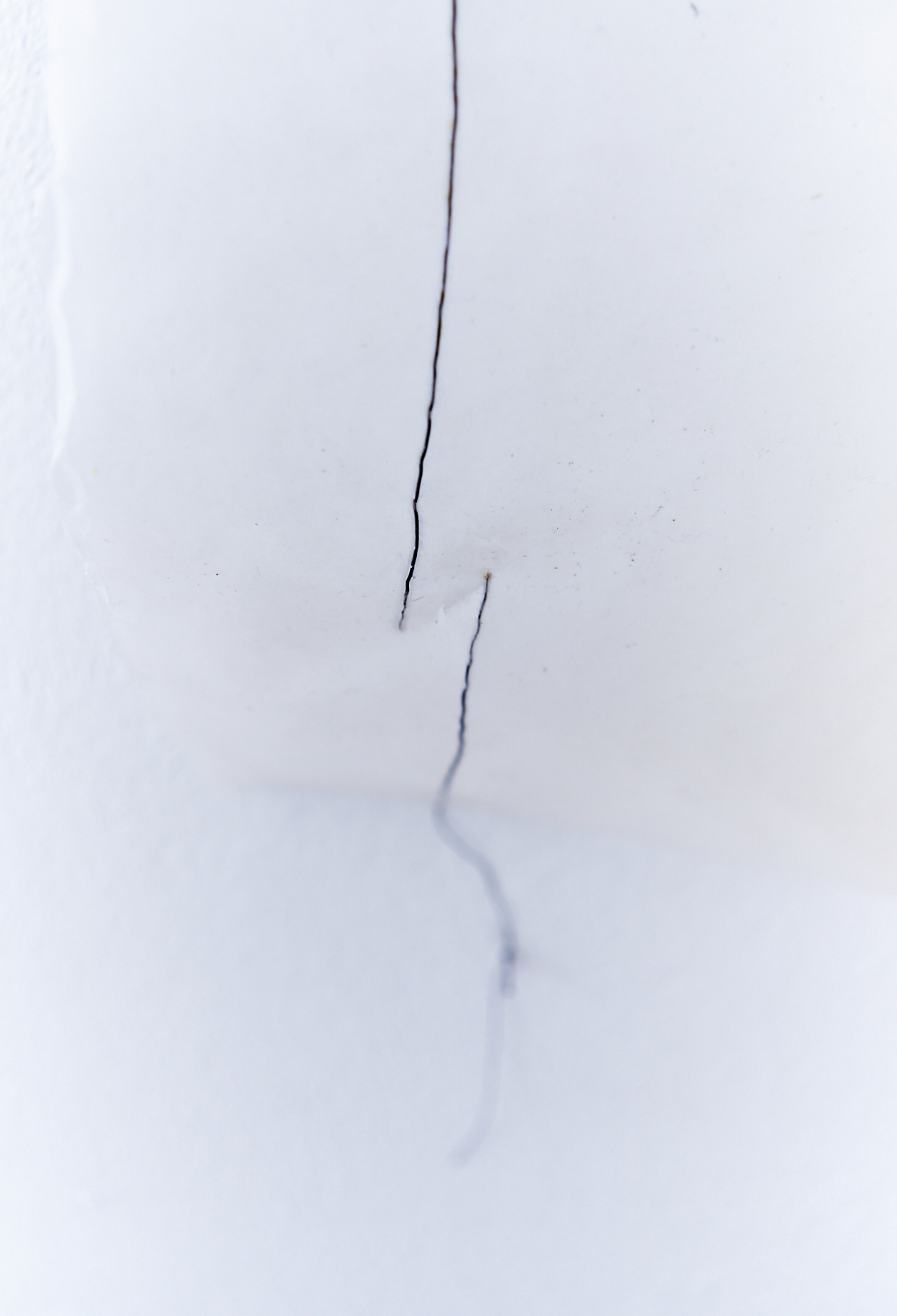 two black wire lines on a white wall